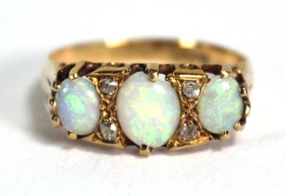 Lot 841 - An 18ct yellow gold ring set three graduated...