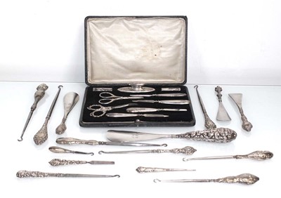 Lot 354 - A group of silver mounted button hooks and...