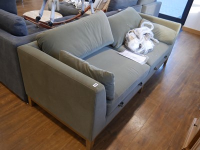 Lot 1390 - Dark green fabric upholstered sofa on wooden...