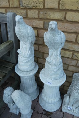 Lot 2057 - Pair of concrete seated golden eagles on plinths
