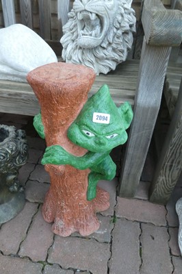 Lot 2094 - Concrete painted goblin climbing tree