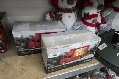Lot 2187 - Pair of Santa themed musical glitter trucks