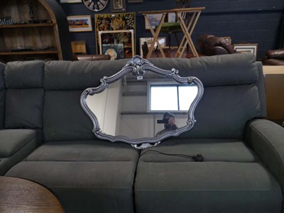 Lot 1446 - Ornate mirror in a silver coloured frame