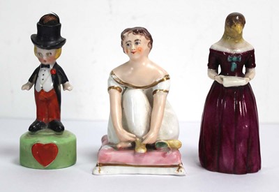 Lot 202 - A novelty candle snuffer modelled as a female...