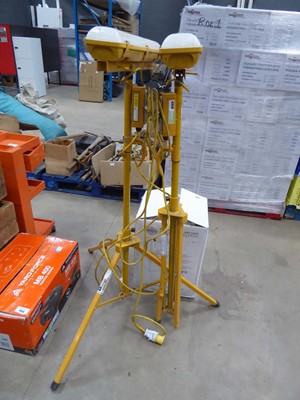 Lot 4359 - 2 yellow 110v site lamps with yellow tripod base