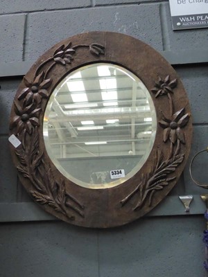 Lot 5334 - Oval bevelled mirror in carved oak frame