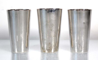 Lot 206 - A set of three German silver beakers, h. 8.5...