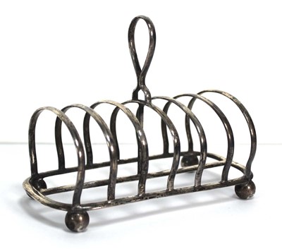 Lot 213 - A silver six slice toast rack on bun feet,...