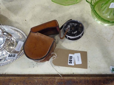 Lot 5015 - Fishing reel in a brown leather case