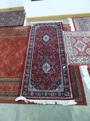 Lot 5045 - Small Persian style runner with red ground and...