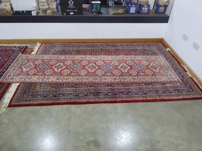 Lot 5047 - Persian style carpet in shades of burgundy and...