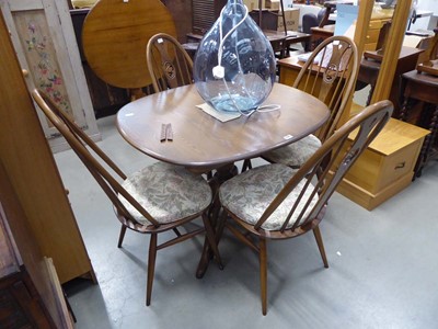 Lot 5184 - Dark Ercol dining table and 4 swan back chairs