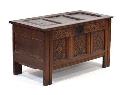Lot 22 - An 18th century oak coffer, the panelled top...
