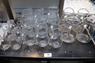 Lot 762 - Table top of various sized glass water jugs....