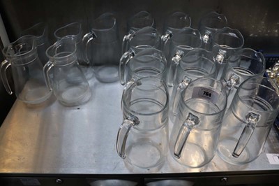 Lot 764 - Table top of various sized glass water jugs....