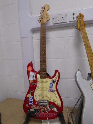 Lot 2261 - Squire Strat six string electric guitar in red...