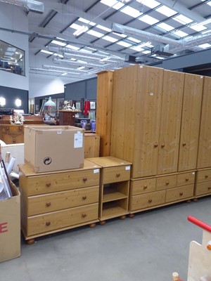 Lot 5226 - Faux pine triple wardrobe with drawers under...
