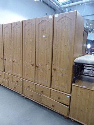 Lot 5227 - Faux pine triple wardrobe with drawers under...