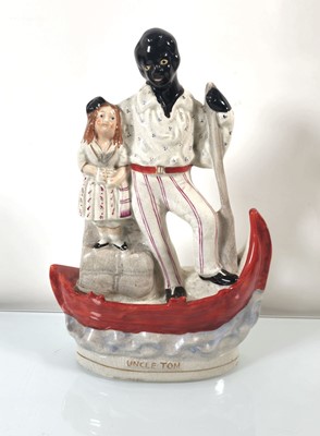 Lot 156 - A Staffordshire flatback modelled as Uncle Tom...