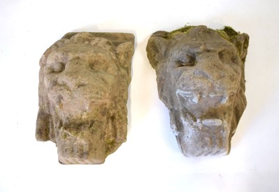 Lot 25 - A pair of weathered composite relief lion...