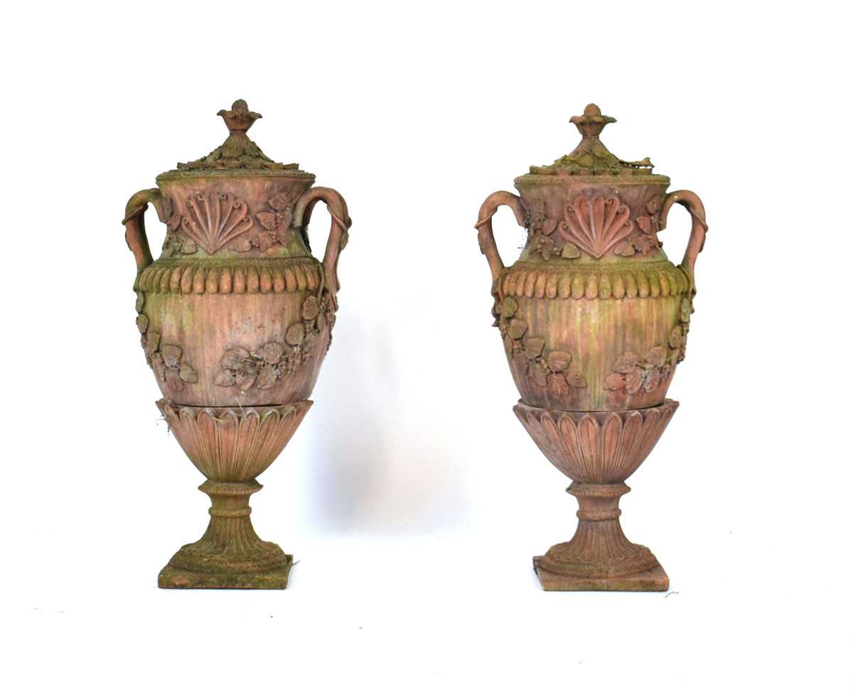 Lot 27 - A pair of terracotta covered planters on...