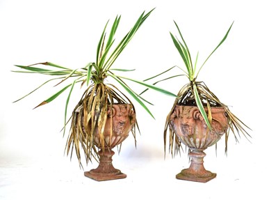 Lot 28 - A pair of terracotta planters with grotesque...