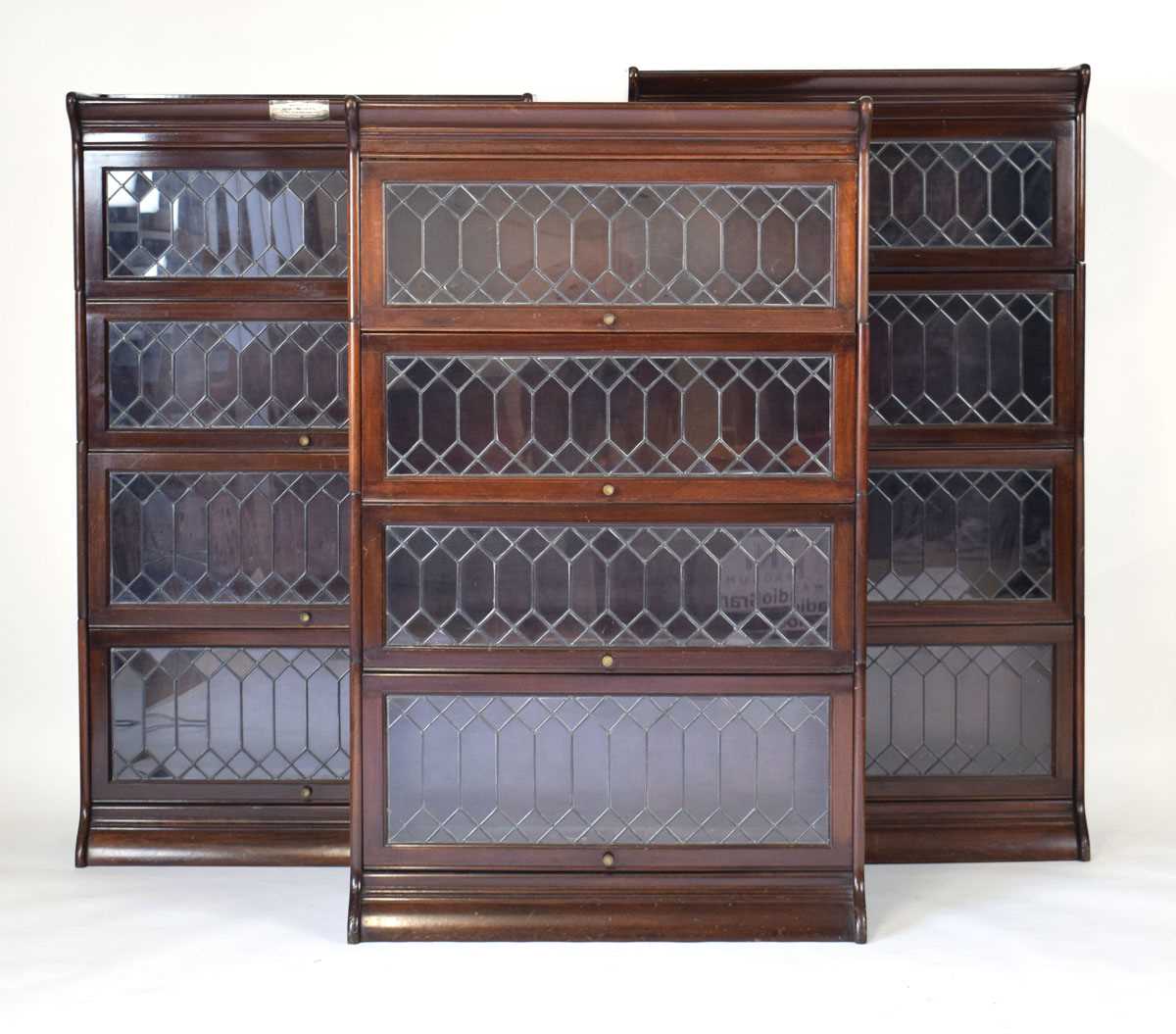 Lot 34 - A set of three Globe Wernicke style mahogany...