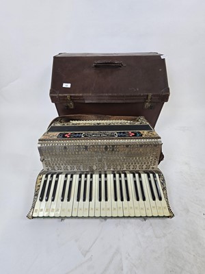 Lot A tan leather cased piano accordion with...