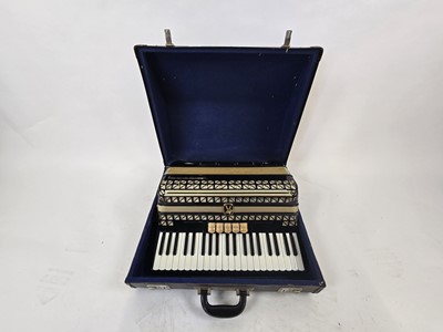 Lot A black leather cased Hohner Vitruola III...