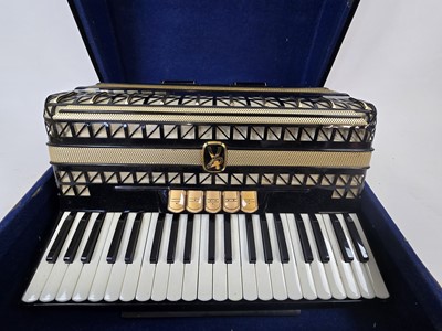 Lot A black leather cased Hohner Vitruola III...