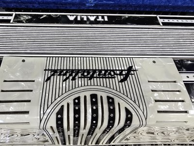 Lot A black leather cased Frontallini piano...