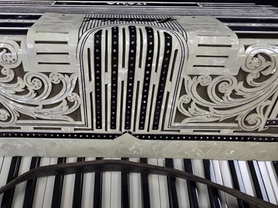 Lot A black leather cased Frontallini piano...