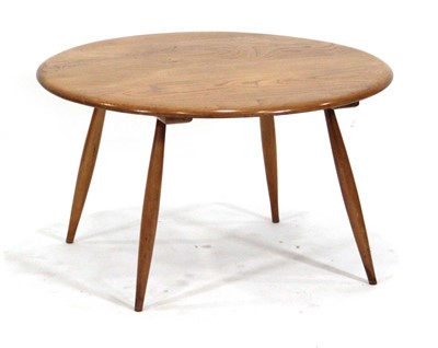 Lot 120 - An Ercol elm circular occasional table on...
