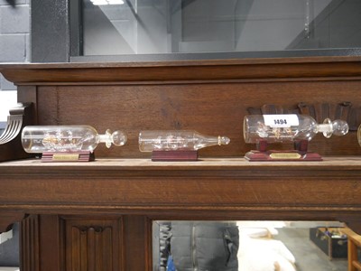 Lot 1494 - Range of glass ships in bottles on small...