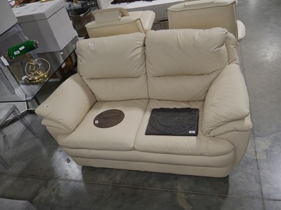 Lot 1039 - Cream leatherette upholstered 2 seater sofa