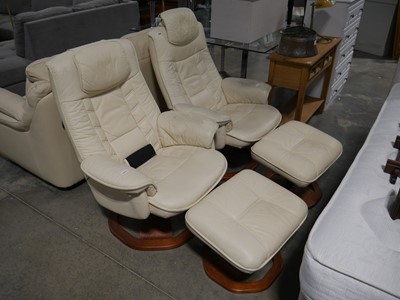 Lot 1053 - Pair of cream leather upholstered swivel easy...