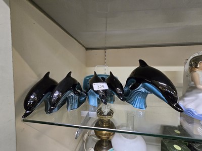Lot 329 - Five Poole Pottery dolphins along with a Poole...