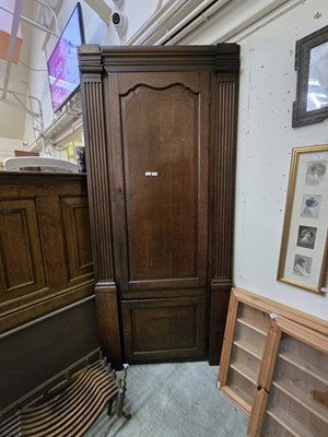 Lot 28 - A substantial oak full height corner cabinet...