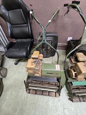 Lot 184 - A vintage green metal petrol lawnmower by Sims