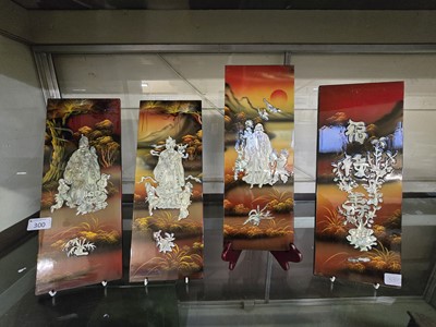 Lot 300 - Four oriental lacquered wall plaques depicting...