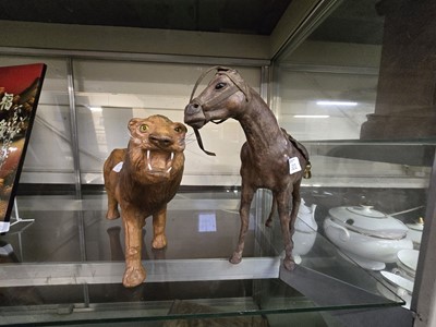 Lot 301 - Two leather bound models of a horse and a lion