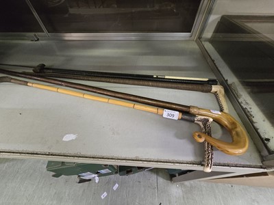 Lot 309 - Five walking canes and riding crops to include...