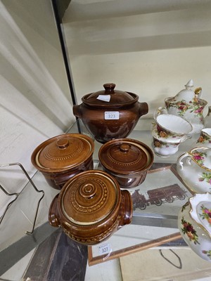 Lot 323 - Two graduated pairs of lidded stoneware pots...