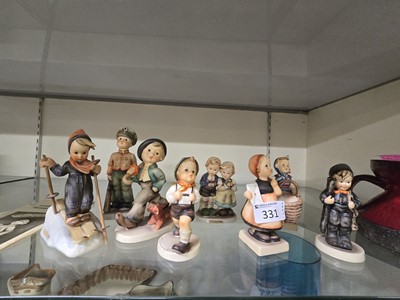 Lot 331 - A collection of eight Goebbel Hummel figures...