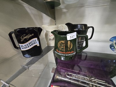 Lot 337 - Four Wade ceramic whisky jugs advertising for...