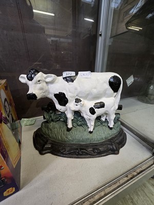 Lot 372 - A painted cast metal door stop in the form of...