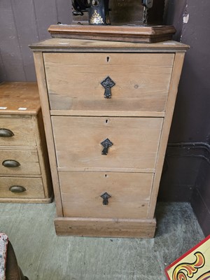 Lot 77 - A distressed stripped pine three drawer filing...