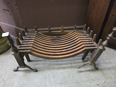 Lot 27 - Cast metal fire grate on brass and cast metal...