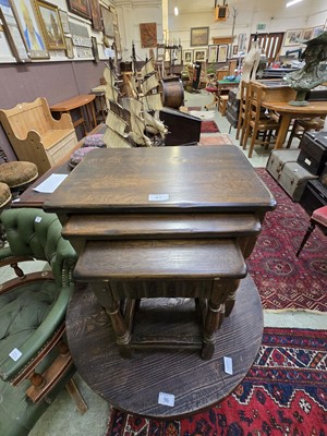 Lot 97 - A nest of three oak occasional tables