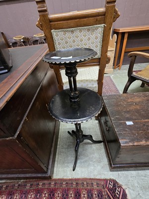 Lot 99 - A black painted two tier wooden cake stand on...